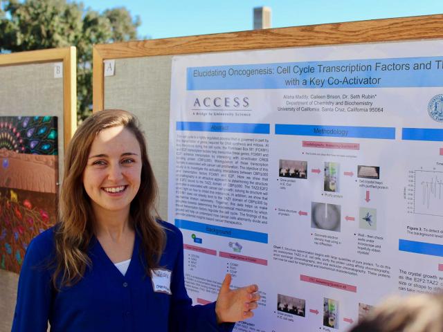 Alisha Maddy (CCS Chemistry/Biochemistry) presenting her research and an original painting at RACA-CON; Photo: Stu Feinstein.