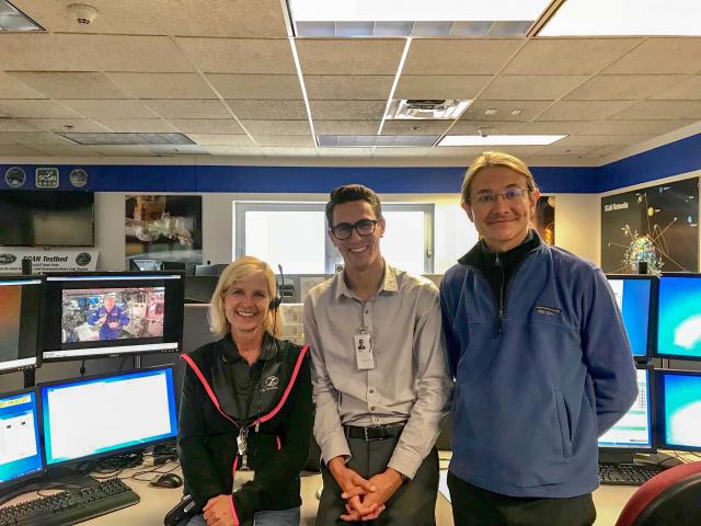 Nick Rommelfanger (center) with Professor Paolo Luzzatto-Fegiz (right) at Glenn Research Center. The video stream of Astronaut Alex Gerst on the ISS is visible on the upper left monitor.