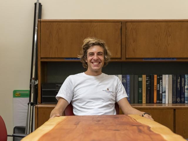 Nick Harvey (CCS Chemistry & Biochemistry '14) with the hand-crafted redwood table he donated to CCS