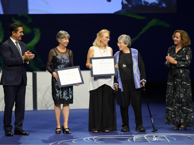 Marlene Zuk '77 (CCS Biology) second on the left receiving her honor