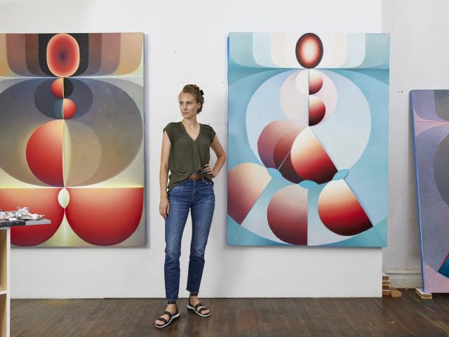 Loie Hollowell ‘05 (CCS Art) with paintings; Photo Courtesy: pacegallery.com