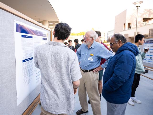 Professor Emeritus Don Aue at a poster presentation