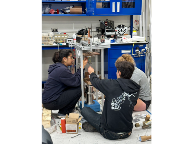 Haley Fogg, Jack Kingdon, and Janhavi Singhal working on the internal wiring of the bubble chamber in the Lippincott Lab