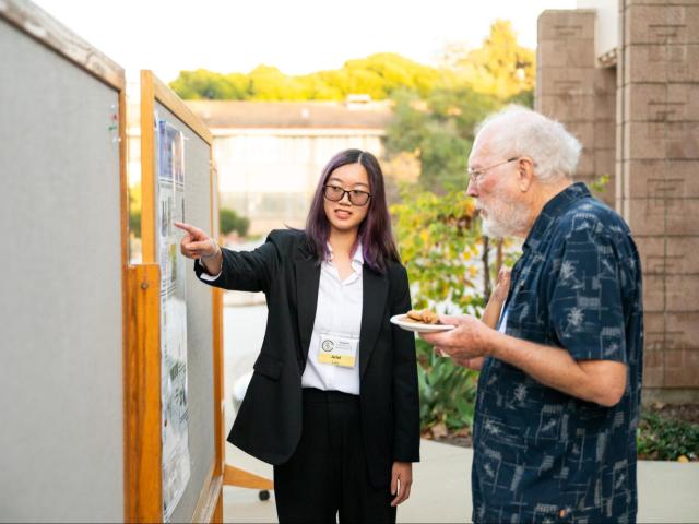 Professor Emeritus of Chemistry Donald H. Aue and a CCS poster presenter